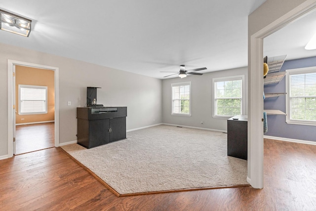 2571 Rourke Dr, Aurora, IL 60503 - unfurnished living room featuring wood finished floors, ceiling fan, and baseboards