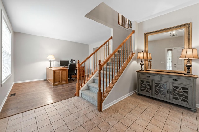 2571 Rourke Dr, Aurora, IL 60503 - stairway featuring healthy amount of natural light, tile patterned floors, and baseboards