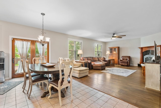 2571 Rourke Dr, Aurora, IL 60503 - dining space with a chandelier, a ceiling fan, and light tile patterned floors