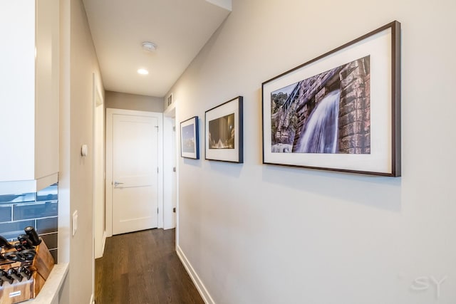 corridor featuring baseboards, dark wood-style floors, visible vents, and recessed lighting
