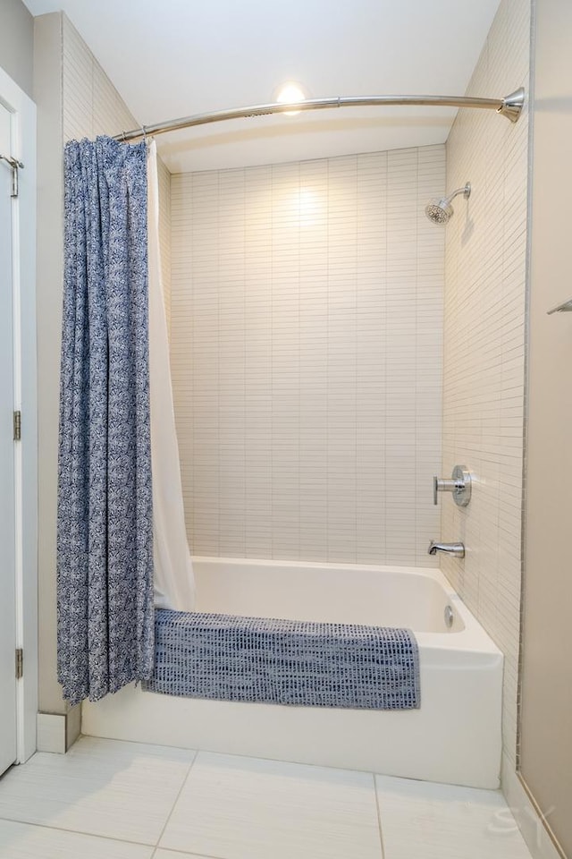 full bathroom with shower / bath combo with shower curtain and tile patterned flooring