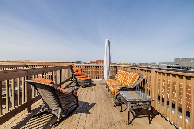 wooden terrace with an outdoor living space