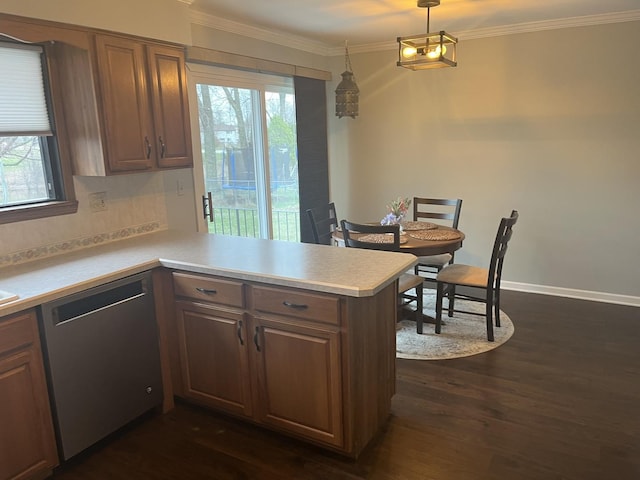 kitchen featuring dishwasher, light countertops, a wealth of natural light, a peninsula, and dark wood finished floors