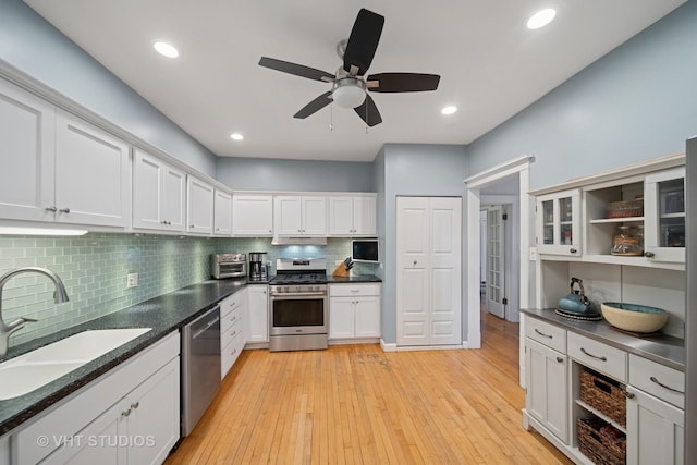 5141 S Greenwood Ave Unit 1, Chicago, IL 60615 - kitchen featuring decorative backsplash, white cabinets, stainless steel appliances, a sink, and light wood-style floors