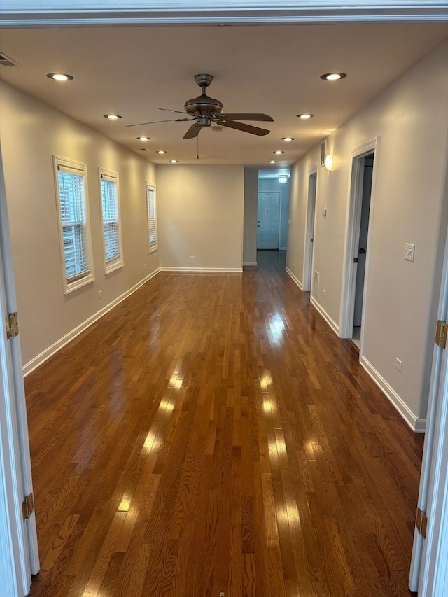 empty room with a ceiling fan, dark wood-style flooring, baseboards, and recessed lighting