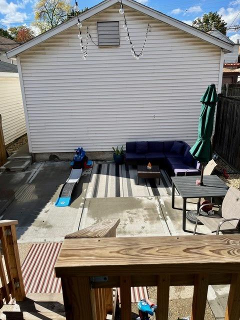 exterior space with an outdoor hangout area, fence, and a patio