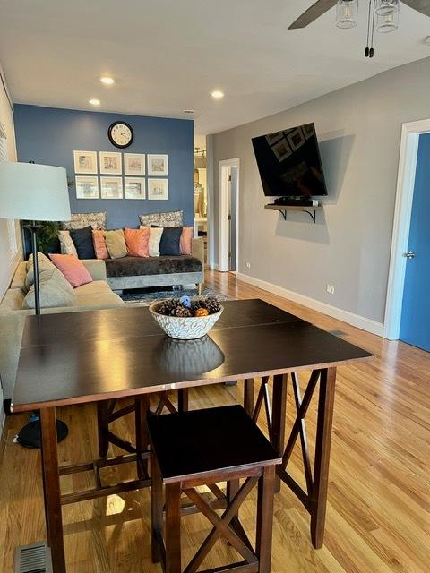 living room with baseboards, ceiling fan, recessed lighting, and light wood finished floors