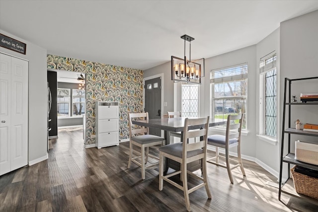 dining space featuring dark wood-style flooring, baseboards, and a healthy amount of sunlight