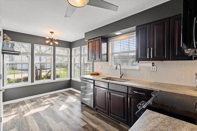 kitchen featuring light countertops, a healthy amount of sunlight, a sink, and dishwasher