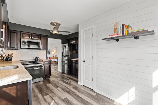 kitchen with a sink, backsplash, dark brown cabinets, and stainless steel appliances