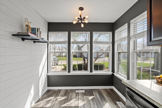 unfurnished sunroom featuring visible vents and a chandelier
