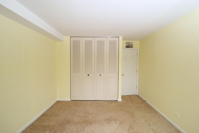 945 E Kenilworth Ave Unit 429, Palatine, IL 60074 - unfurnished bedroom featuring light carpet, a closet, and baseboards