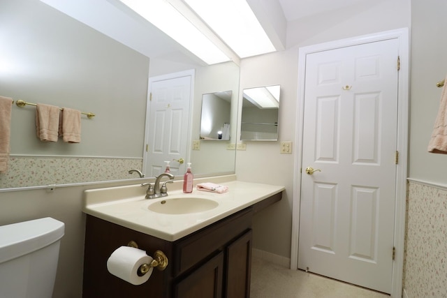 945 E Kenilworth Ave Unit 429, Palatine, IL 60074 - half bathroom featuring vanity, toilet, wallpapered walls, and a wainscoted wall