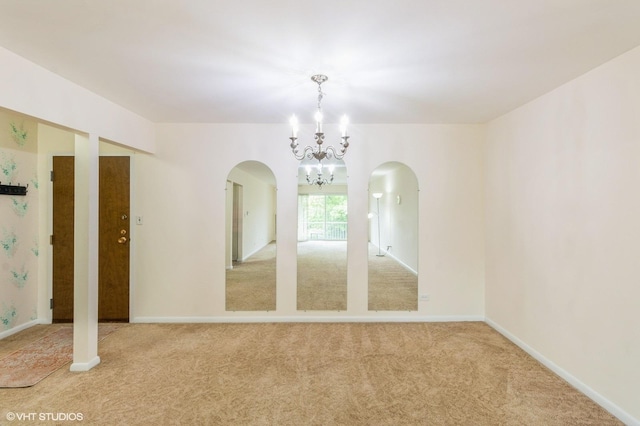 945 E Kenilworth Ave Unit 429, Palatine, IL 60074 - empty room featuring arched walkways, a chandelier, carpet flooring, and baseboards