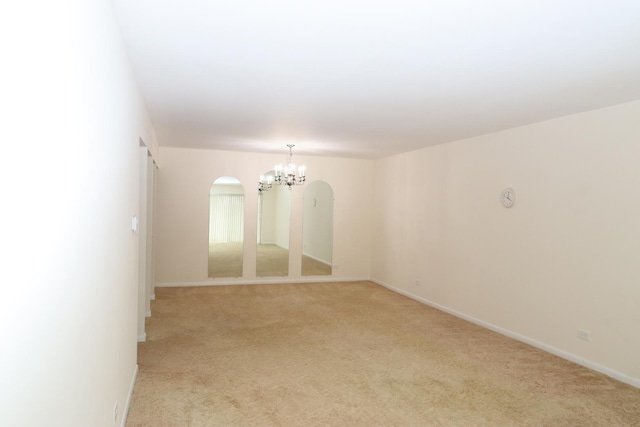945 E Kenilworth Ave Unit 429, Palatine, IL 60074 - unfurnished room with a chandelier, arched walkways, light carpet, and baseboards