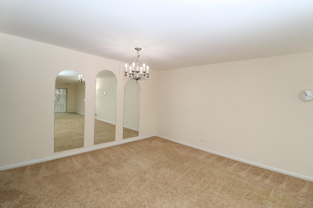 945 E Kenilworth Ave Unit 429, Palatine, IL 60074 - spare room featuring arched walkways, light colored carpet, a chandelier, and baseboards