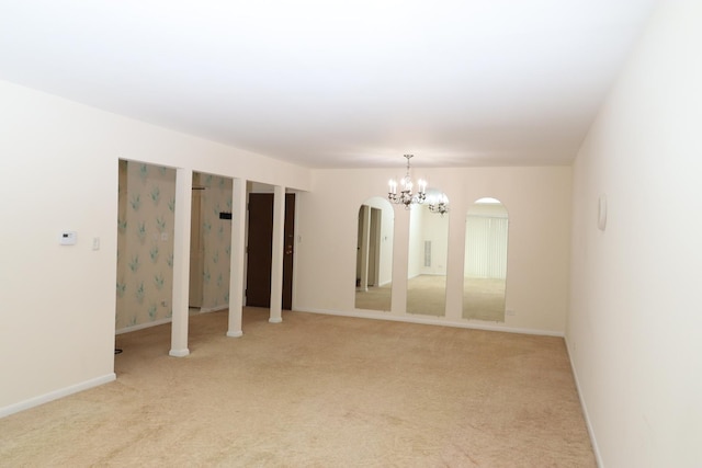 945 E Kenilworth Ave Unit 429, Palatine, IL 60074 - empty room featuring arched walkways, a chandelier, light carpet, and baseboards