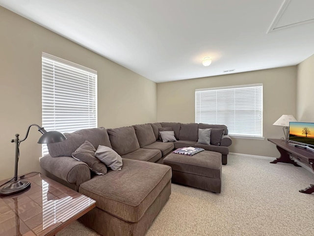 carpeted living room with baseboards and visible vents