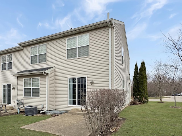 back of house with a patio, a lawn, central air condition unit, and entry steps