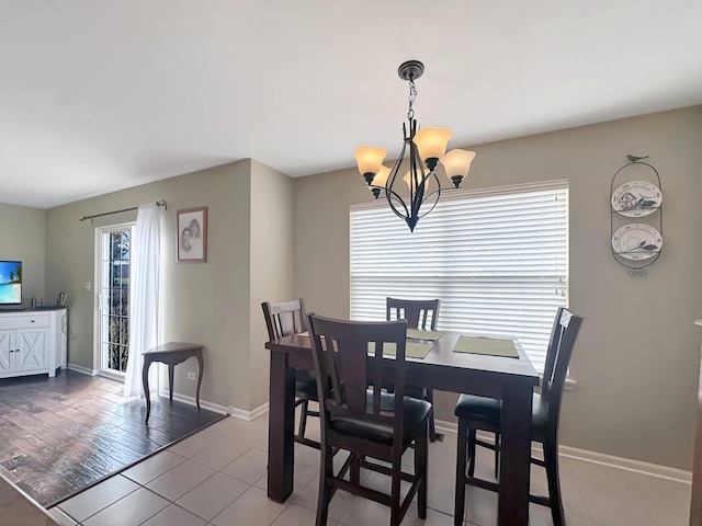 dining room with baseboards and an inviting chandelier