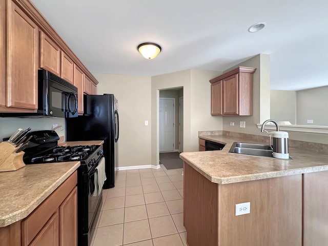 kitchen with light countertops, a peninsula, a sink, black appliances, and light tile patterned floors