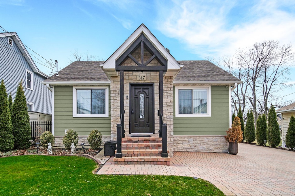 317 Highwood Ave, Highwood, IL 60040 - view of front of home with stone siding and a shingled roof