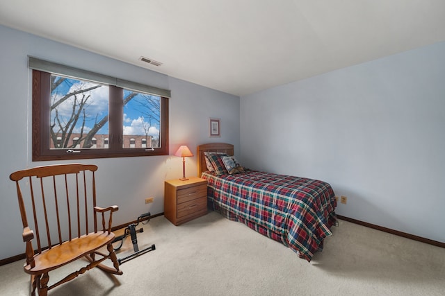 bedroom featuring baseboards, visible vents, and light carpet