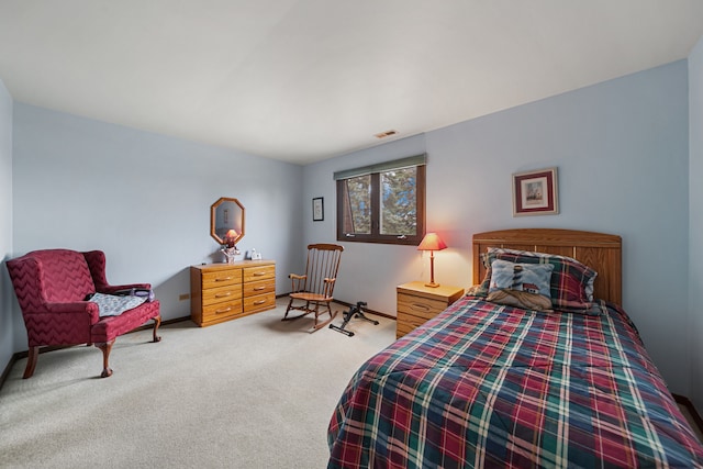 bedroom with light carpet and visible vents