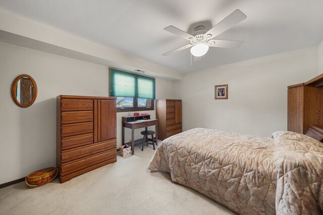 carpeted bedroom with visible vents and ceiling fan