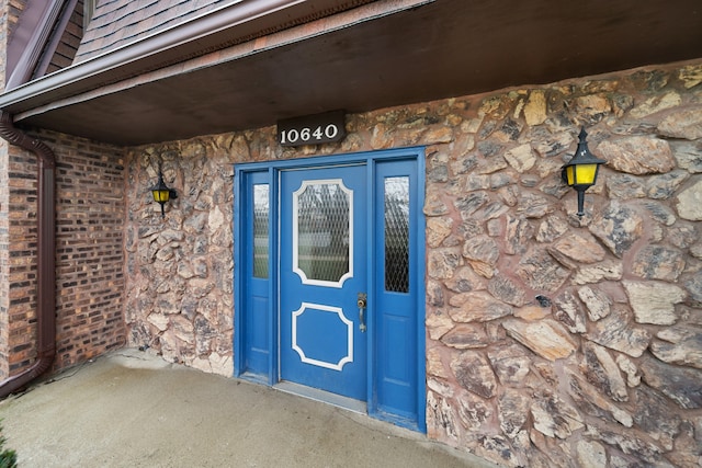entrance to property featuring stone siding
