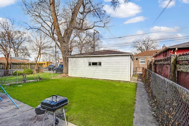 view of yard with a fenced backyard and an outbuilding
