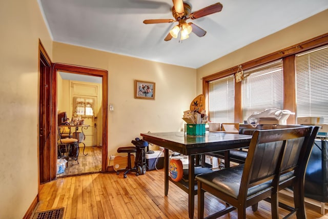 dining room featuring visible vents, ceiling fan, light wood finished floors, and baseboards