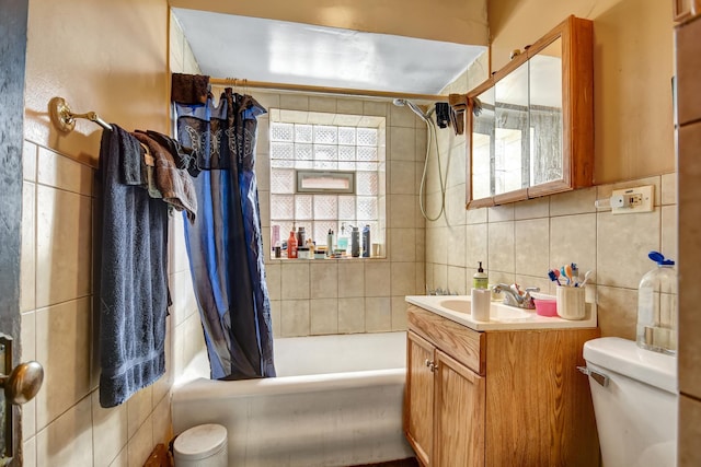 bathroom with vanity, toilet, tile walls, shower / tub combo, and decorative backsplash