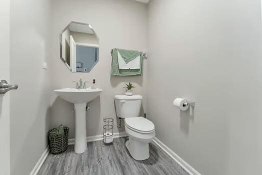 1672 Bentz Way, Batavia, IL 60510 - half bathroom featuring toilet, wood finished floors, baseboards, and a sink