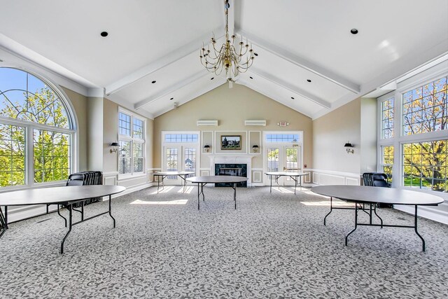 292 Needham Dr, Bloomingdale, IL 60108 - rec room with wainscoting, a glass covered fireplace, carpet, beamed ceiling, and high vaulted ceiling