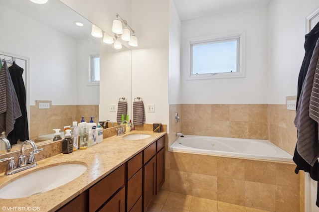 bathroom with a sink, tile patterned floors, double vanity, and a garden tub