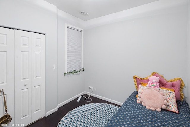 bedroom with visible vents, baseboards, and dark wood-style floors