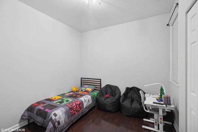 bedroom featuring baseboards and wood finished floors