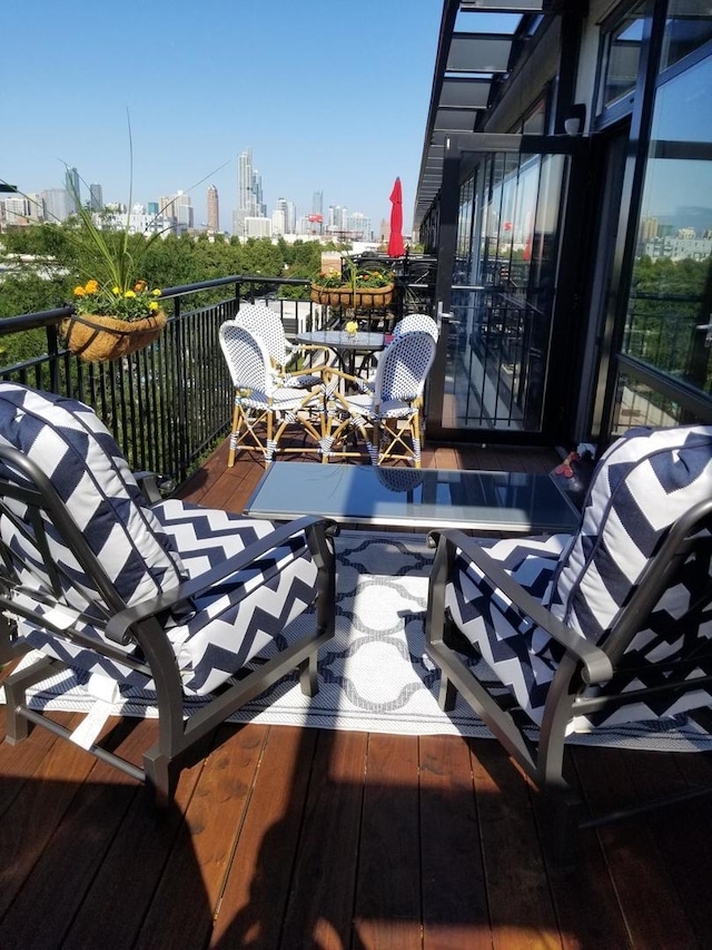wooden terrace featuring a city view