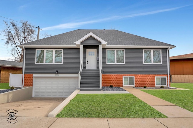 view of front of home with concrete driveway, a garage, a front lawn, brick siding, and a shingled roof