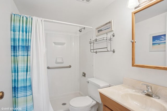 bathroom featuring toilet, vanity, visible vents, and a stall shower
