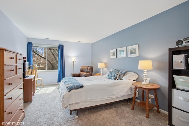 bedroom with baseboards and carpet