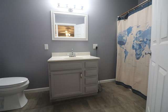 full bathroom featuring vanity, baseboards, tile patterned flooring, toilet, and ceiling fan