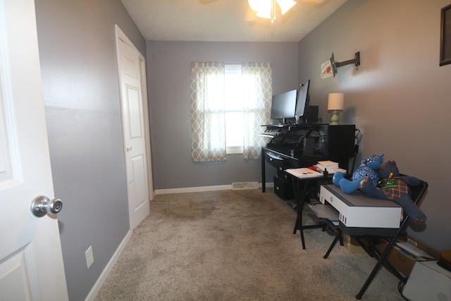 carpeted home office with visible vents, baseboards, and a ceiling fan