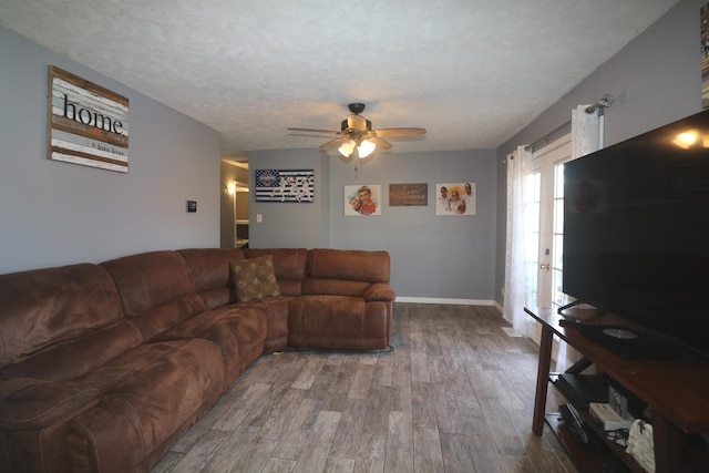 living area featuring ceiling fan and wood finished floors
