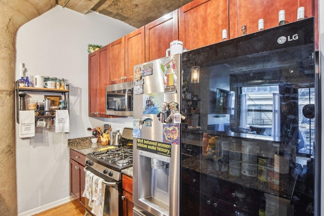 1070 W 15th St Unit 305, Chicago, IL 60608 - kitchen featuring appliances with stainless steel finishes, stone countertops, light wood-style floors, baseboards, and brown cabinetry