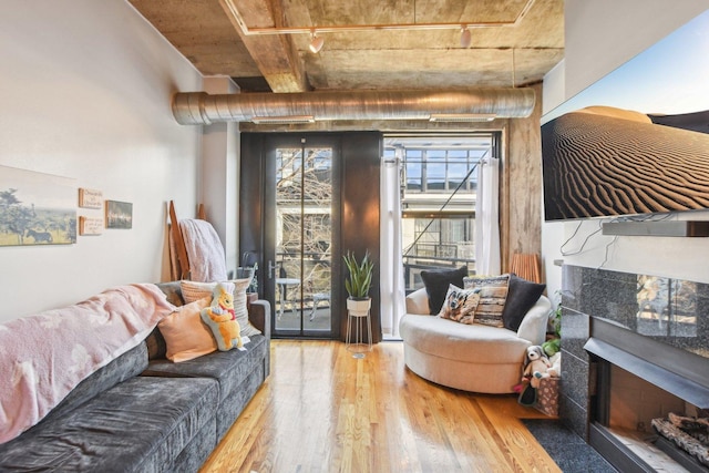 1070 W 15th St Unit 305, Chicago, IL 60608 - living room featuring wood finished floors, a tile fireplace, and track lighting