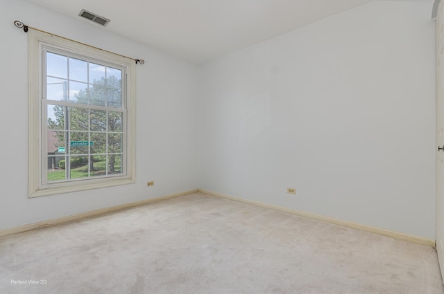 spare room featuring visible vents, carpet floors, and baseboards