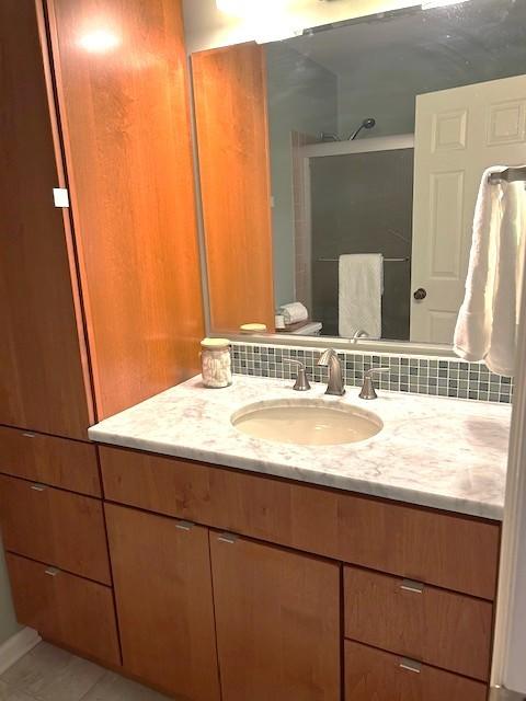 bathroom with a shower and vanity