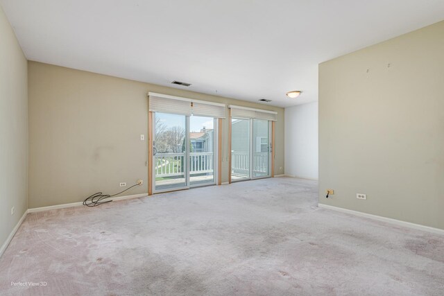 unfurnished room featuring visible vents, carpet floors, and baseboards